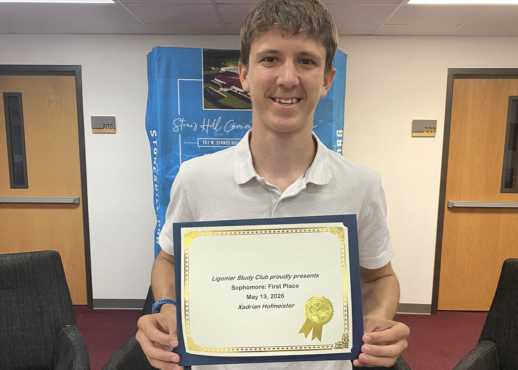 student holding a certificate