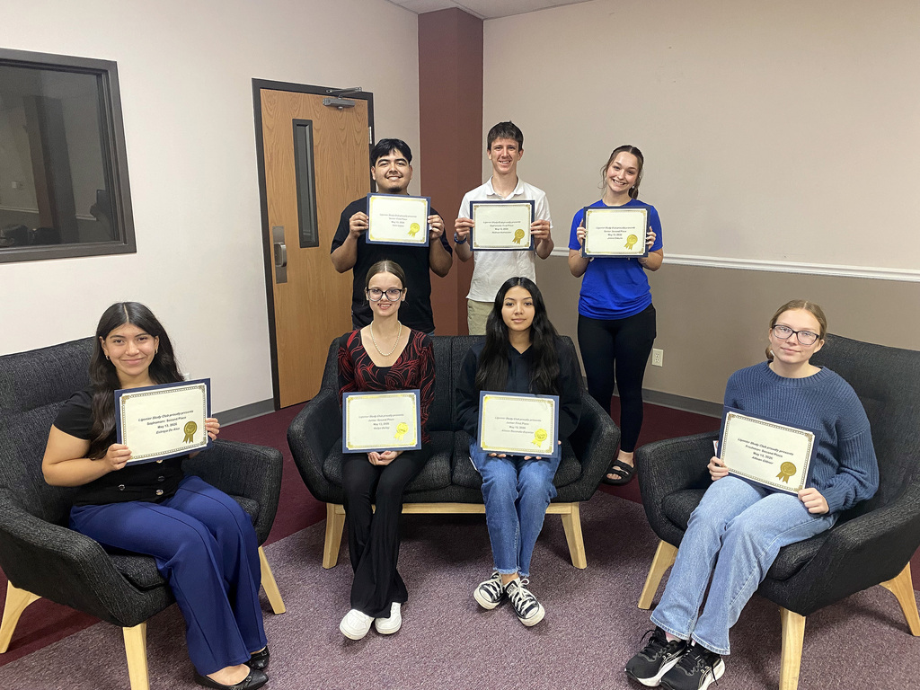 students holding their certificates for awards night
