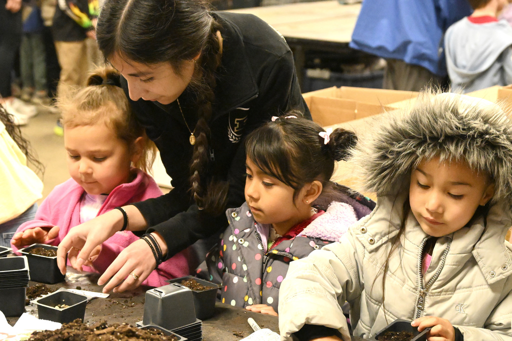 girls planting seeds in dirt