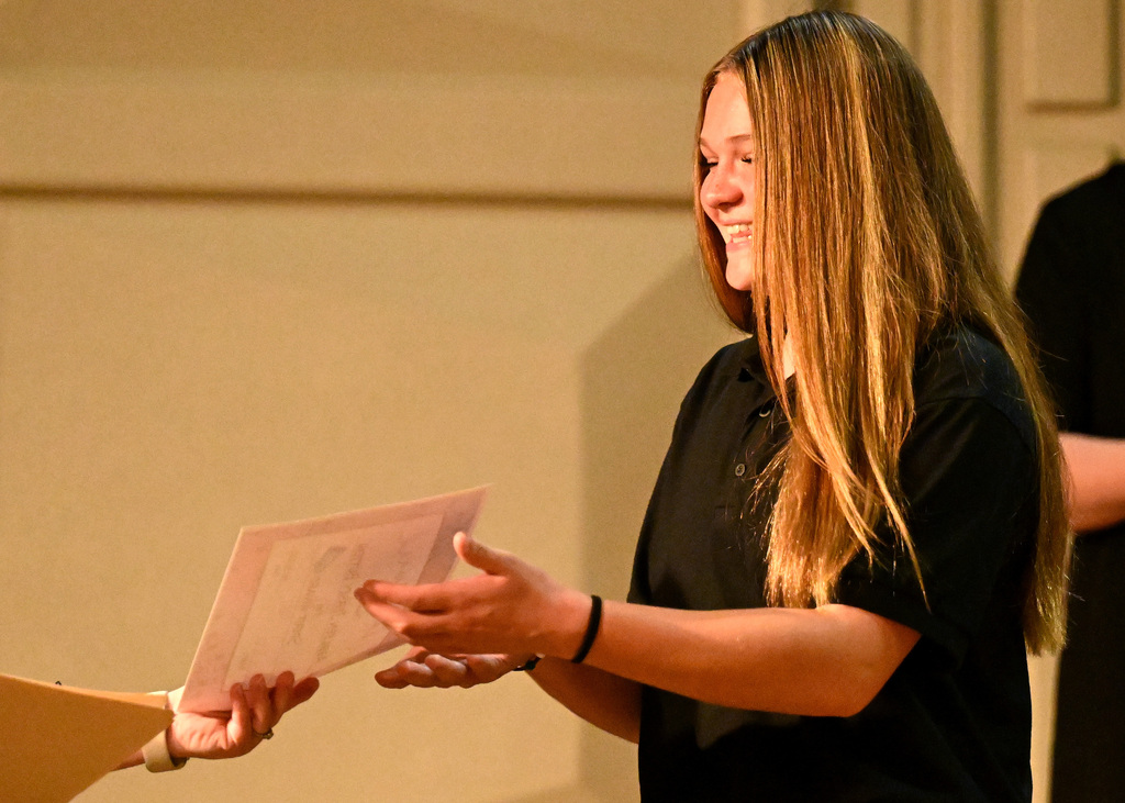 girl getting an award at a concert