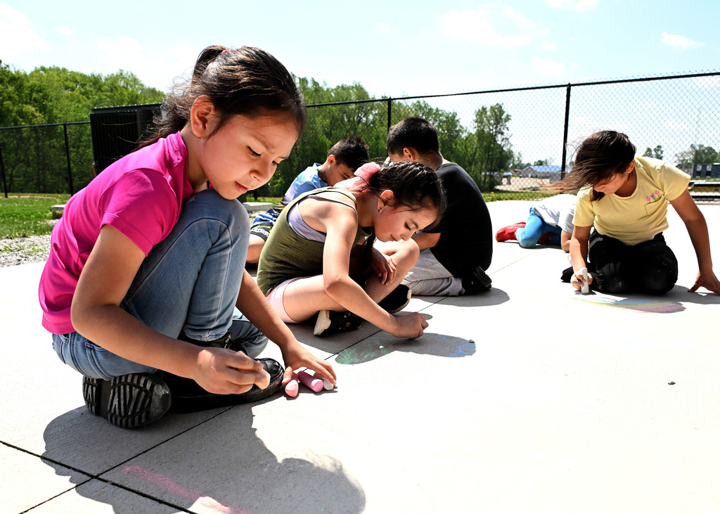 kids coloring with sidewalk chalk