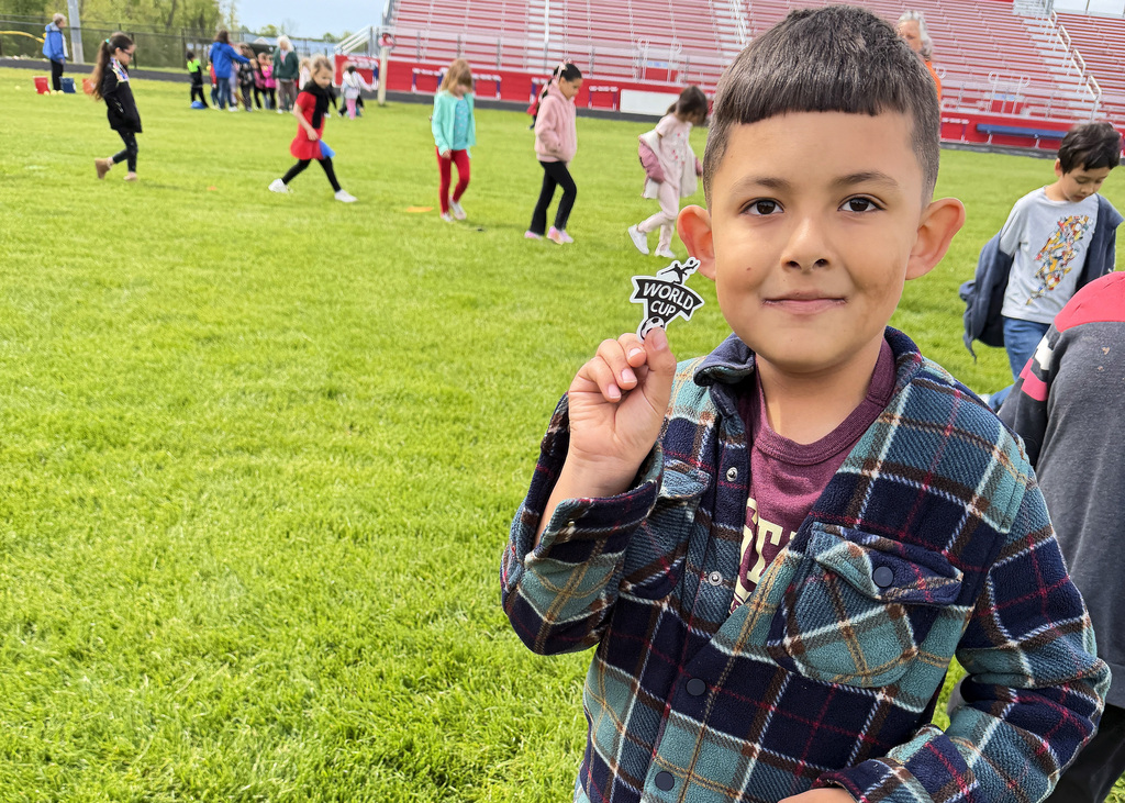 a boy showing his soccer sticker