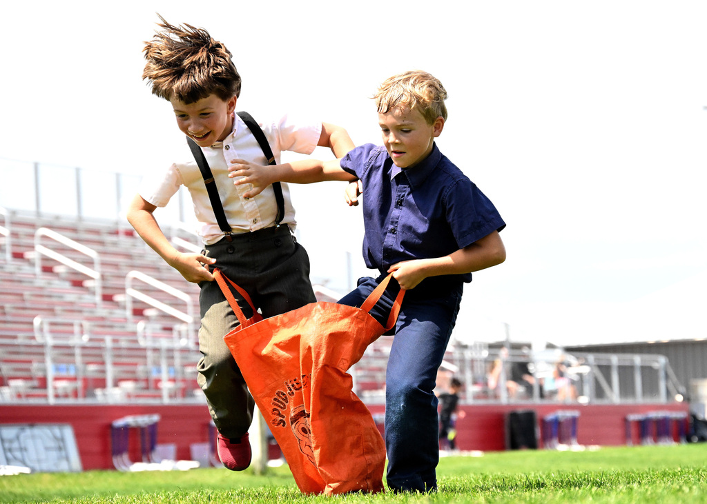 two boys doing a potato sack race