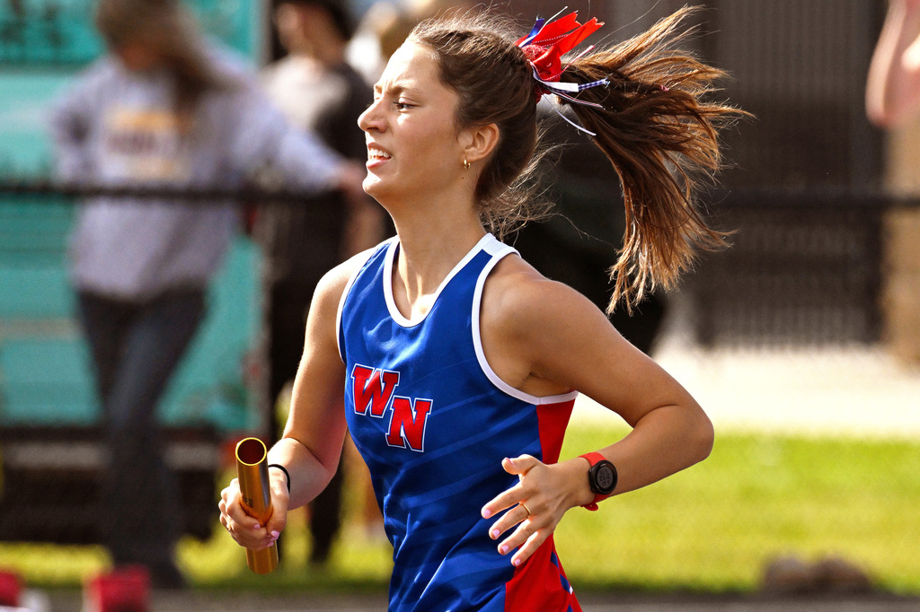 girl running with a baton