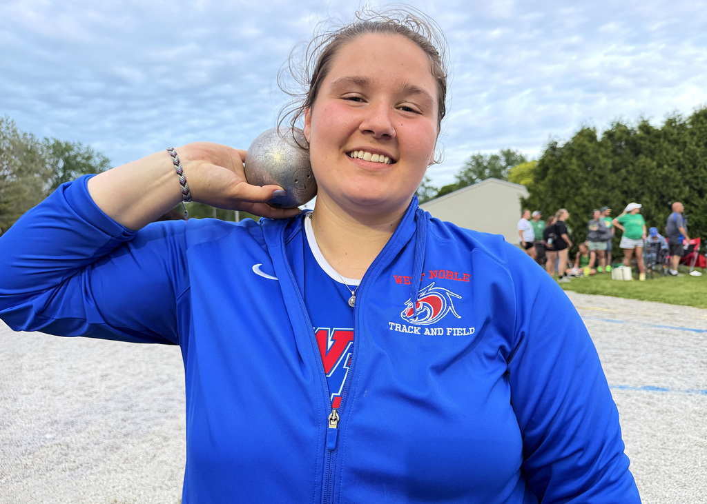 girl posing with a shot put