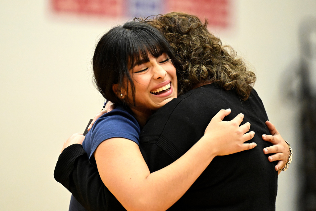student hugging a teacher