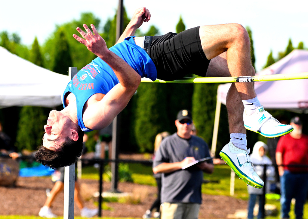 track athlete jumping over the high jump bar