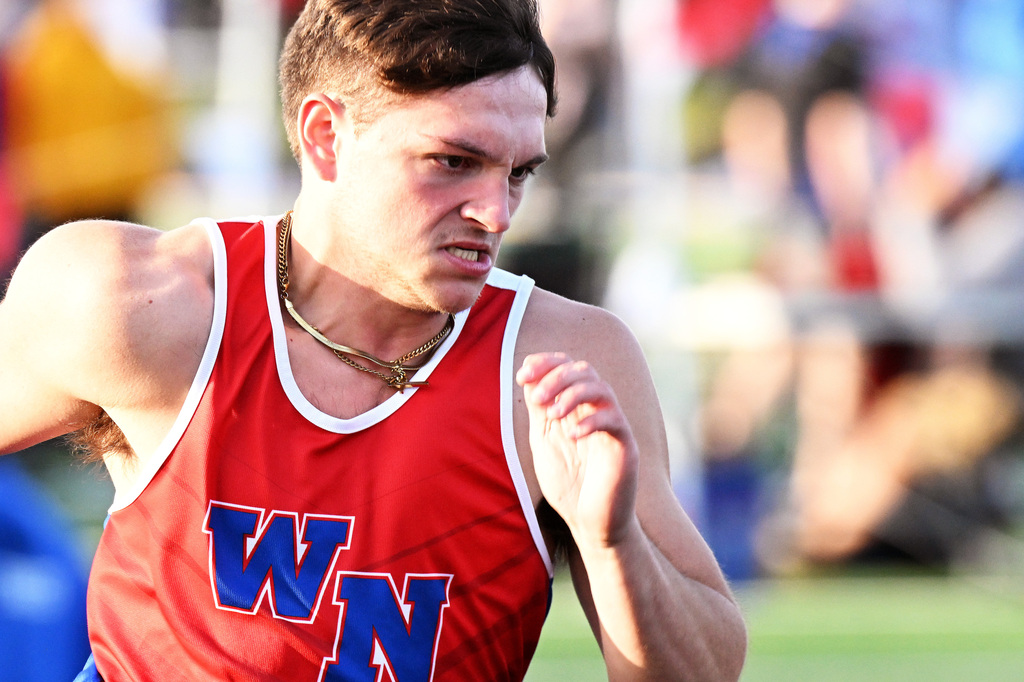 track athlete running around the track