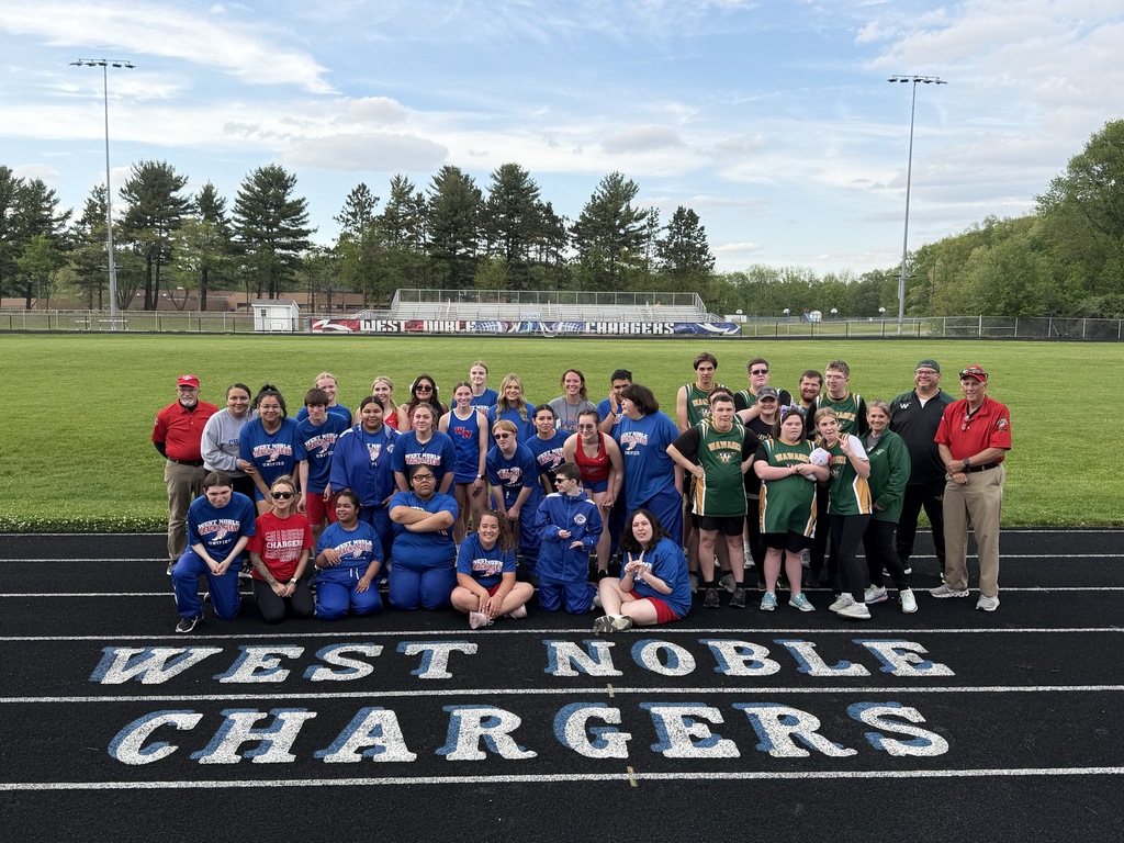 two teams posing at a track meet