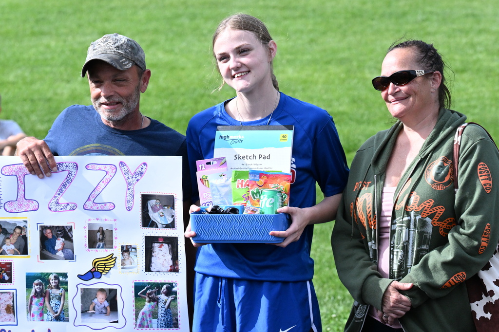 a senior and her parents at senior day