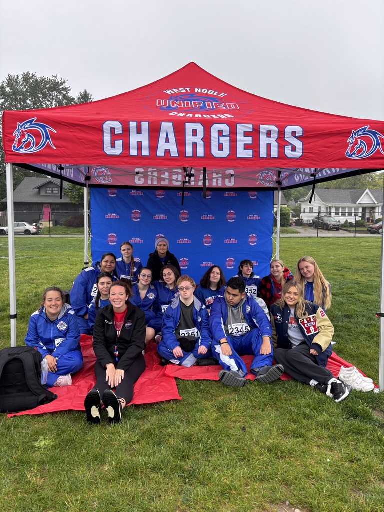 a track team sitting under a tent