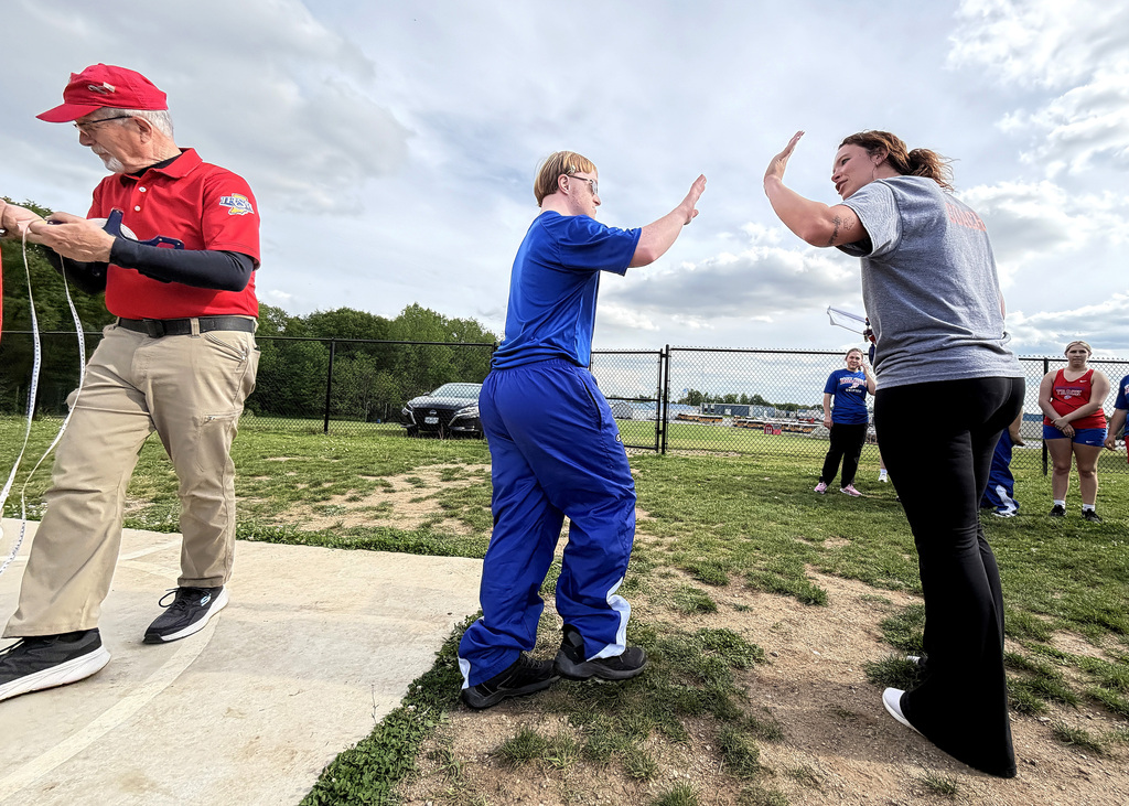 and athlete and his coach high fiving
