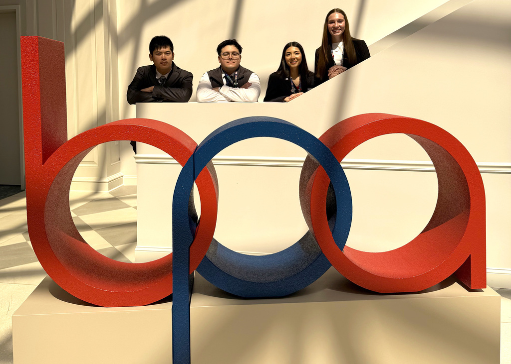 four people by a bpa sign