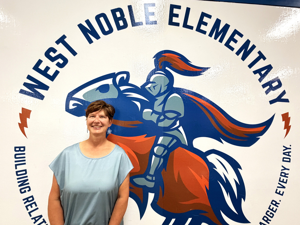 lady standing by a painted mural at the elementary school