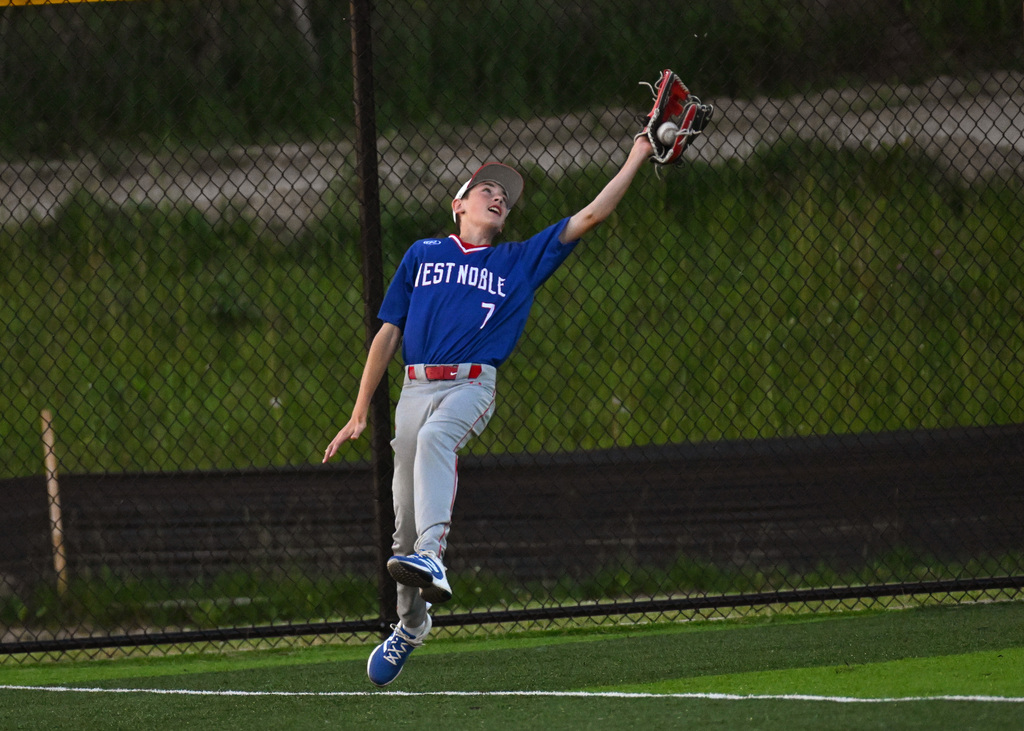a baseball player trying to catch a ball
