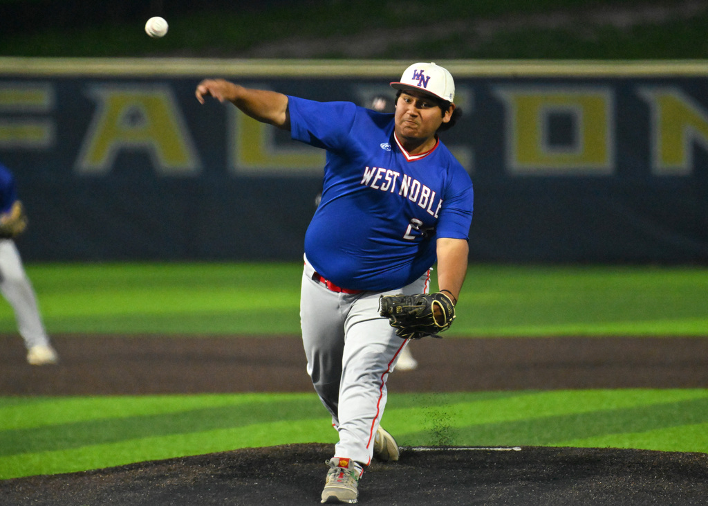 a baseball player pitching a ball