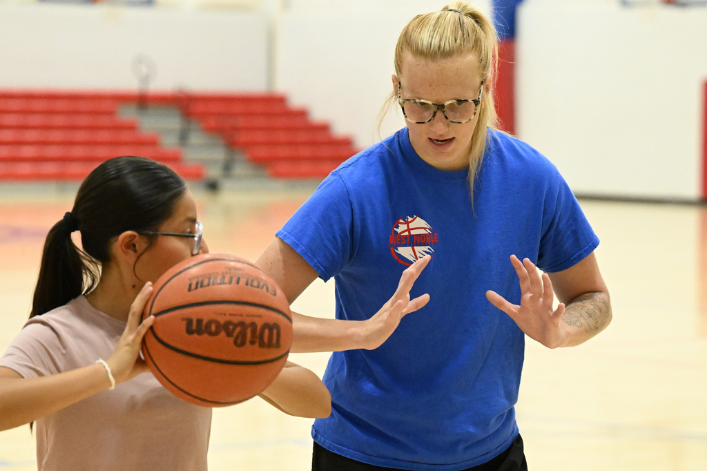 a coach and a player working on basketball skills
