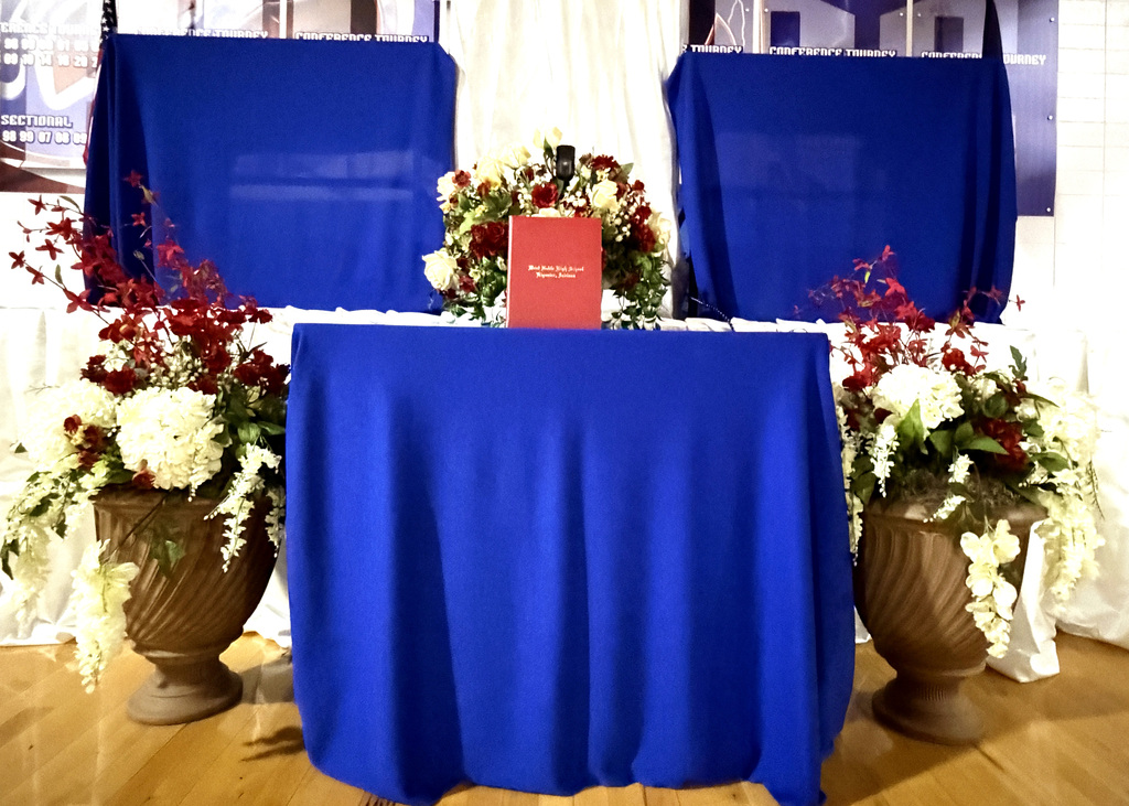mantle setup for a graduation ceremony with flowers and a diploma