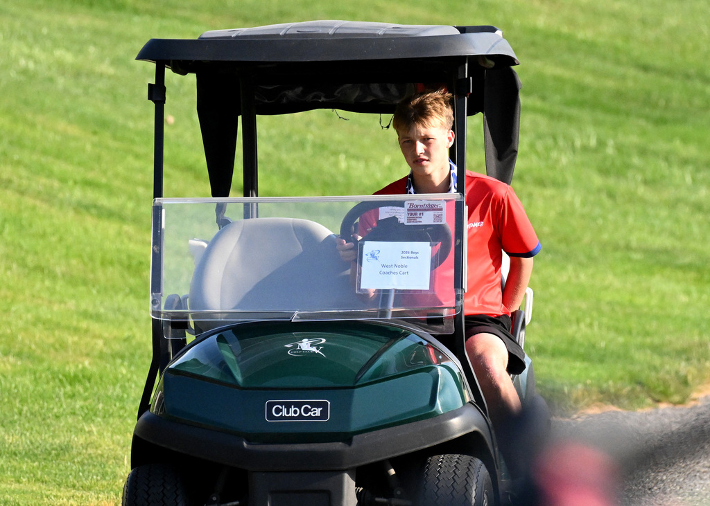 kid driving the golf cart