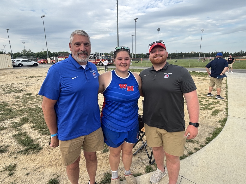 two track coaches and an athlete posing for a picture