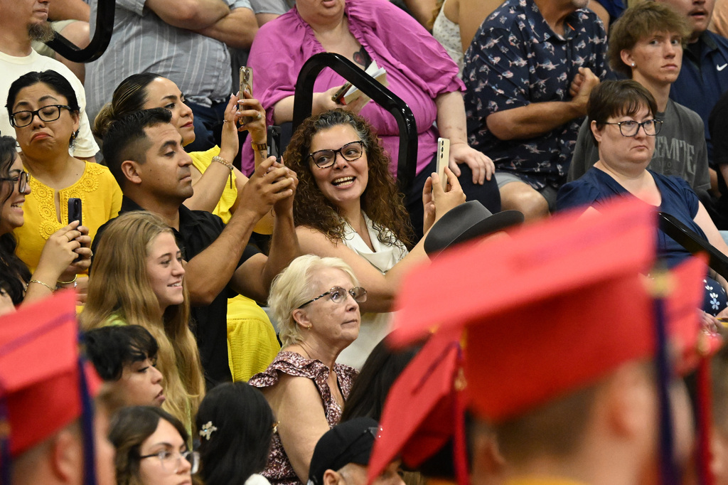 people taking photos at a graduation