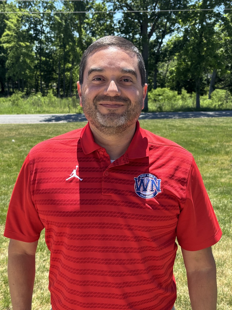 a man in a read shirt posing for a photo