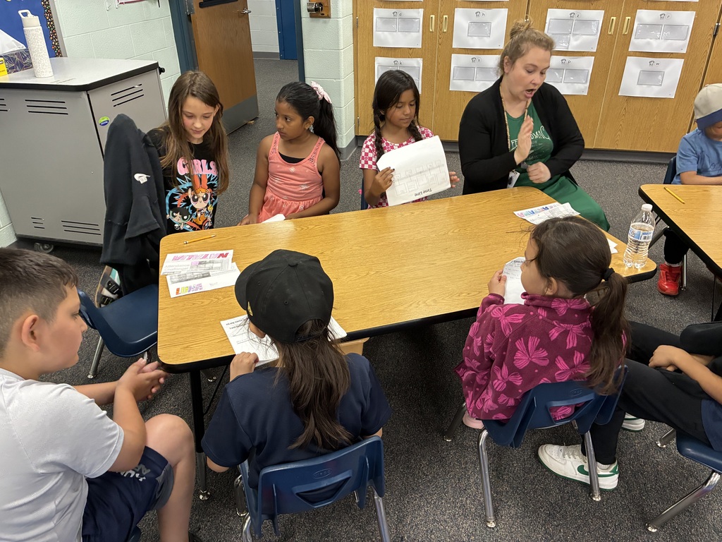 students in a group working on presentations
