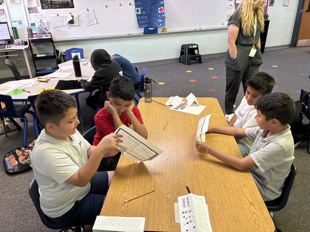 students in a group working on presentations