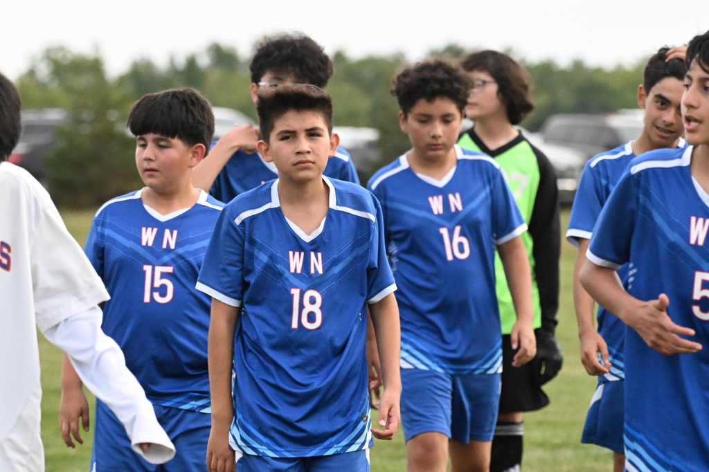 middle school soccer players in blue jerseys