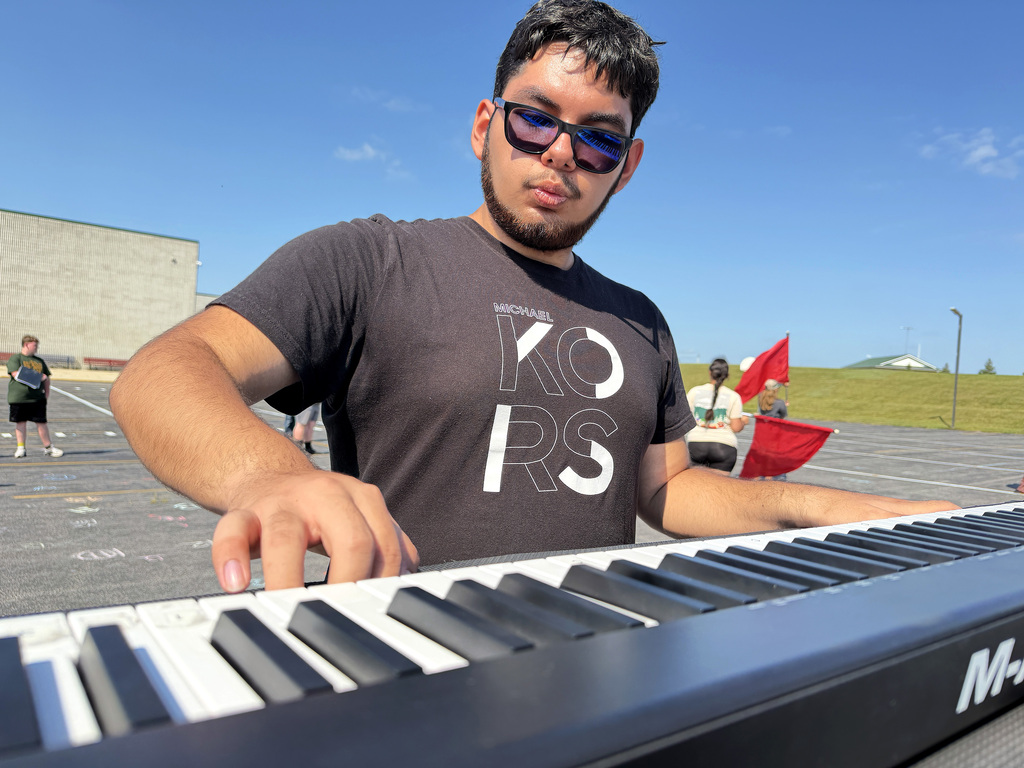 a boy playing the keyboard