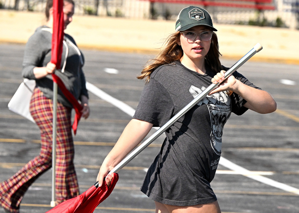 a girl walking with a flag pole