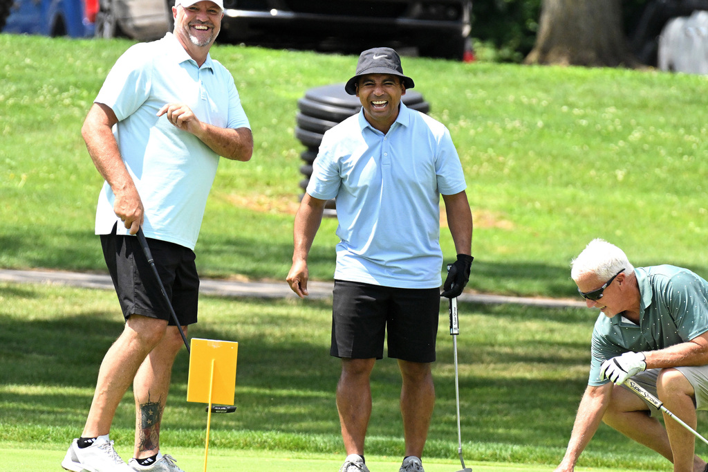 three guys laughing at the golf course