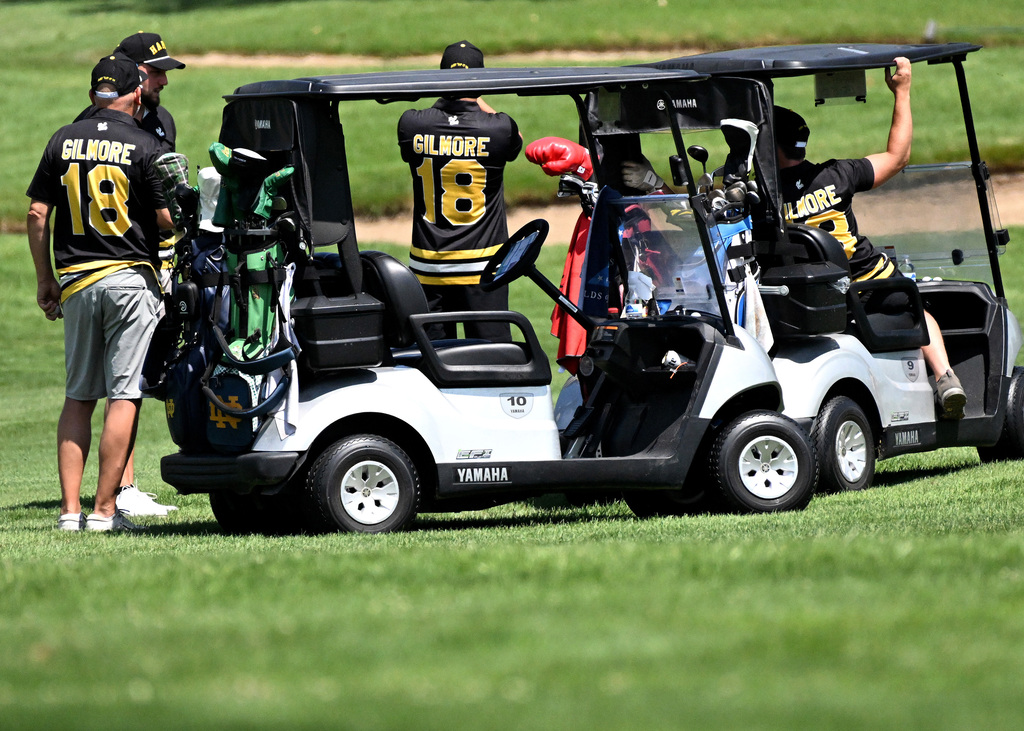 a bunch of happy gilmores by golf carts