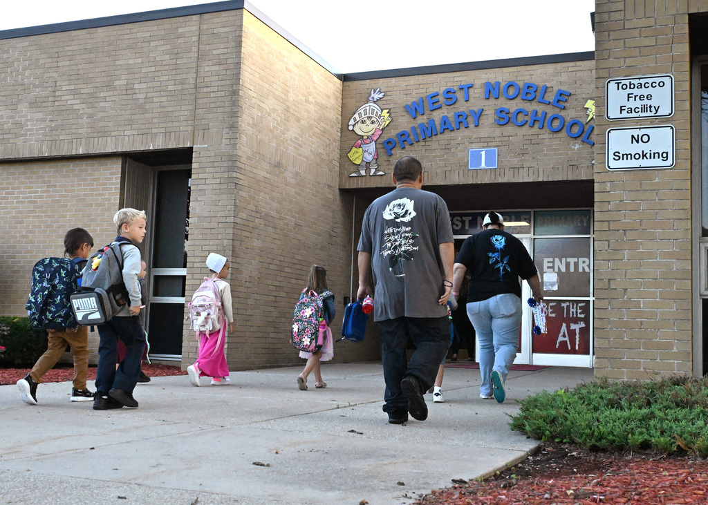 people walking into west noble primary's front entrance