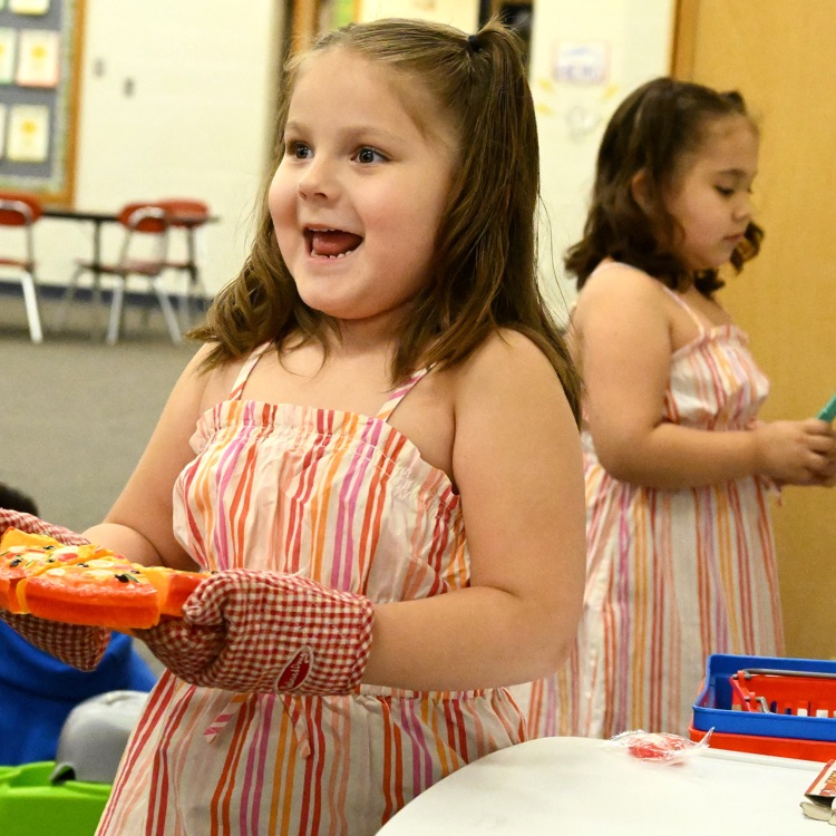 girl carrying a wood pizza