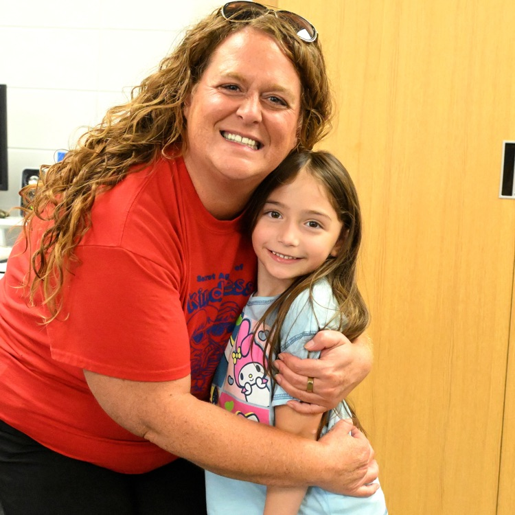 a teacher and student smiling