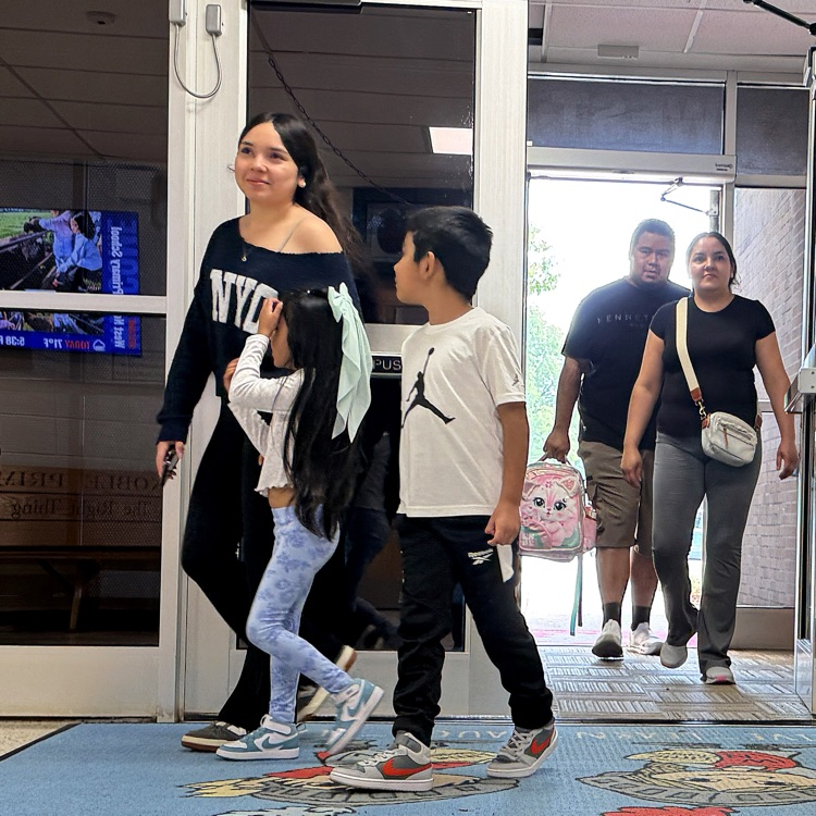 families walking into a building