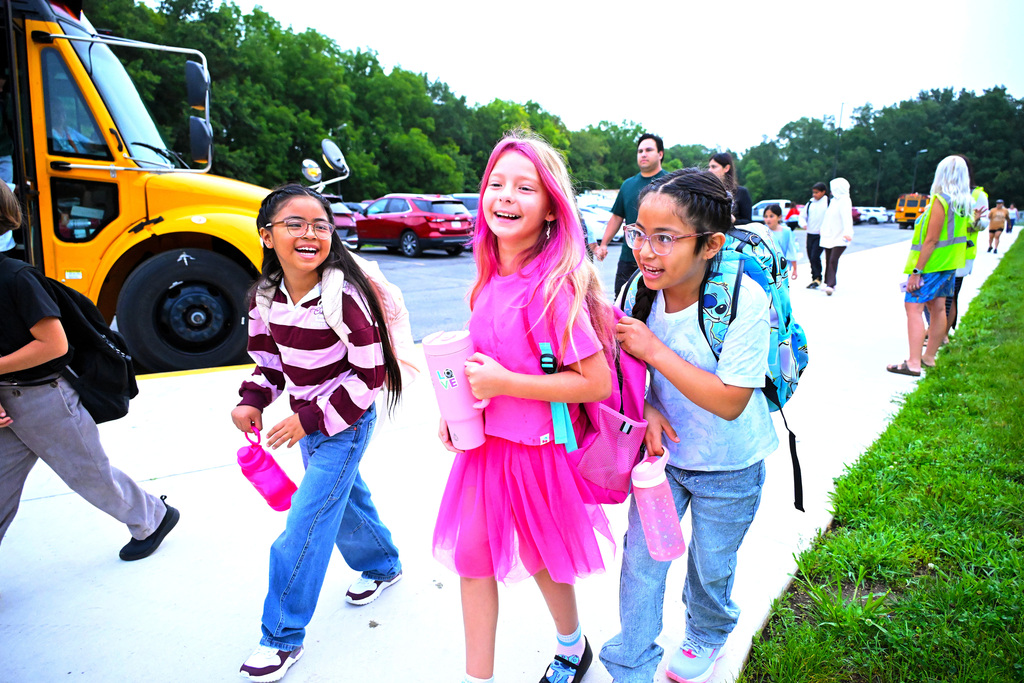 three girls walking and laughing