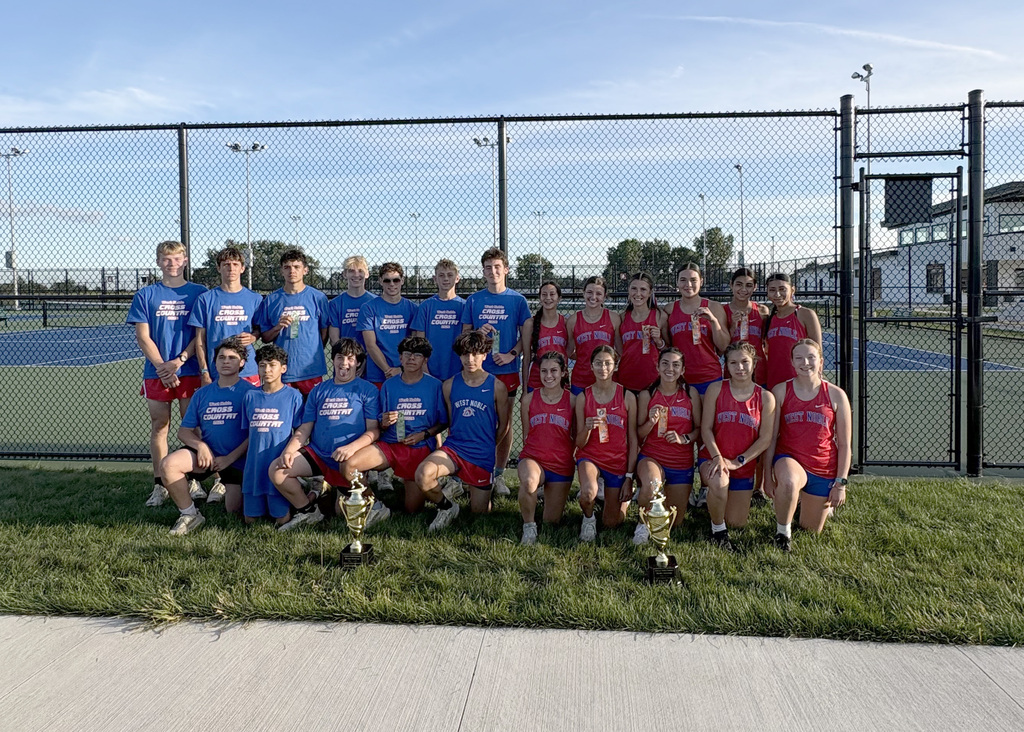 boys and girls cross country teams in a team photo with championship trophies