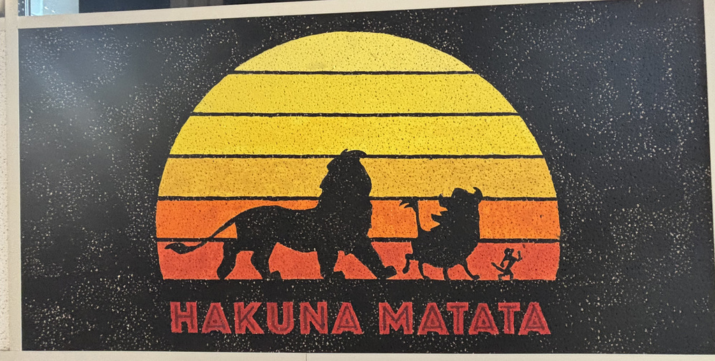 a hakuna matata logo on a ceiling tile