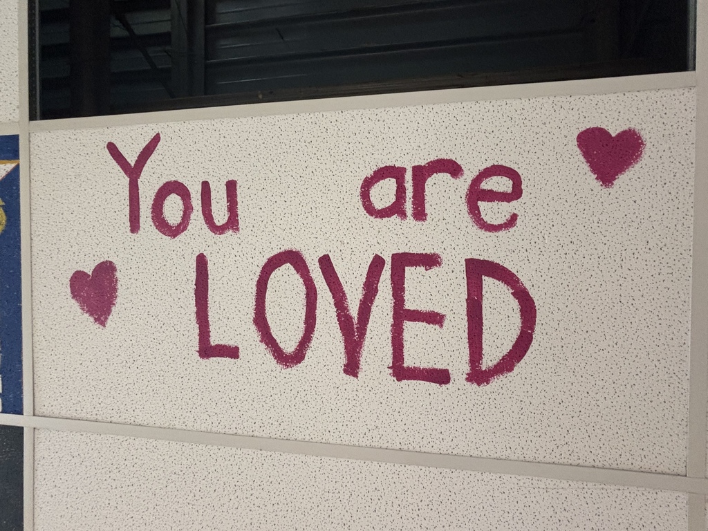 you are loved painted on a ceiling tile