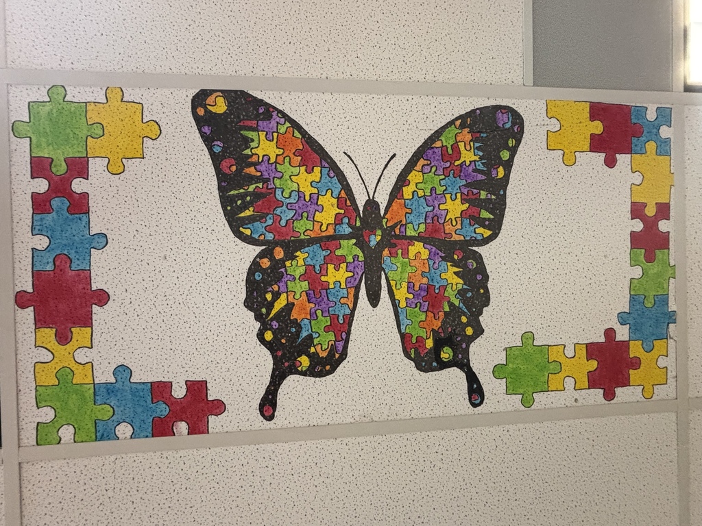 a butterfly painted with puzzle pieces on a ceiling tile