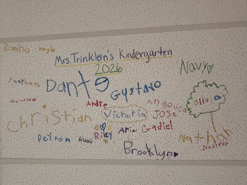 kids names written on a ceiling tile