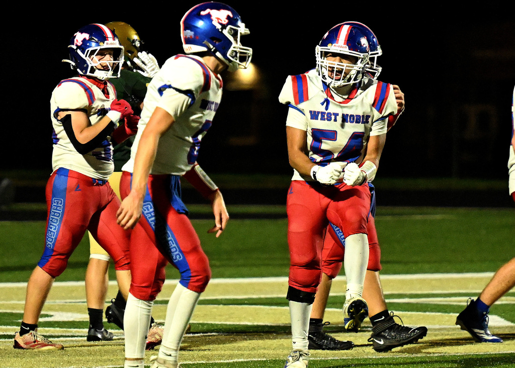 a football player celebrating with his teammates