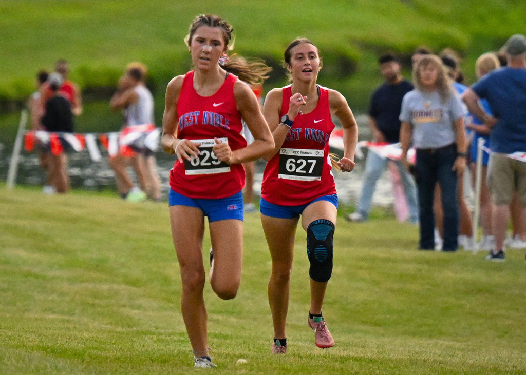 two girls running in red jerseys