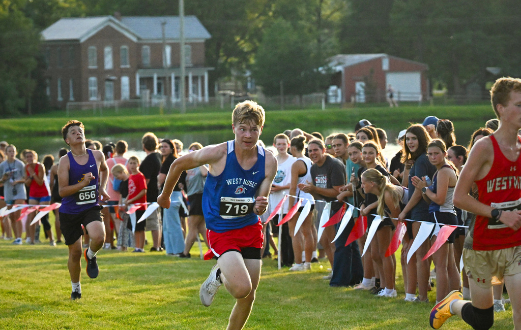 a boy in a blue jersey running