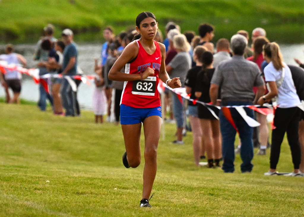 a girl running in a red shirt