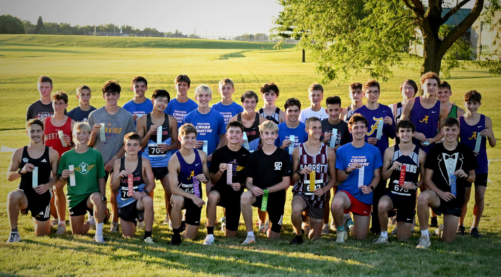 a group of boys posing for a photo with ribbons
