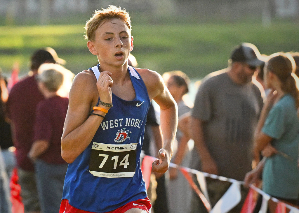 a boy in a blue jersey running