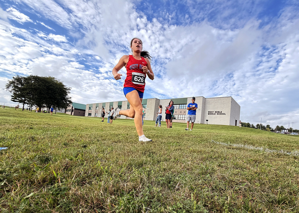 a girl in a red jersey running
